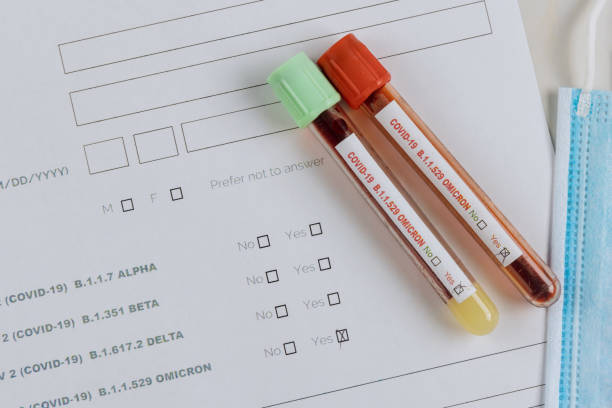A picture showing a sample registration form and two tubes of blood sample